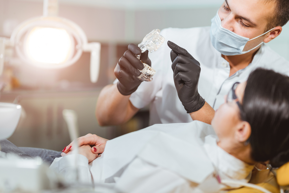 Dentist attending to patient in chair